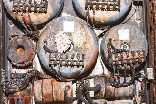 Photography Electrical panel damaged after a fire with charred wires and melted components indicating intense heat exposure