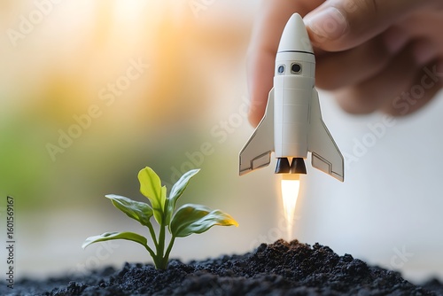 Startup concept with toy rocket launching from soil near a growing plant, symbolizing growth