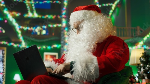 Man dressed as Santa Claus responding to kids requesting gifts, typing on laptop. Person impersonating Santa Claus asking children what they want for Christmas using notebook keyboard, camera A