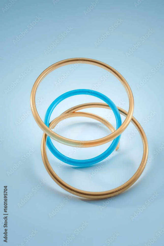 Fototapeta premium Three colorful bangles stacked on a light blue background