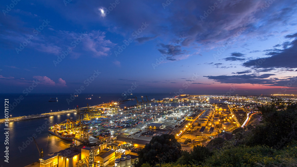 Obraz premium Seaport and loading docks at the port with cranes and multi-colored cargo containers day to night timelapse