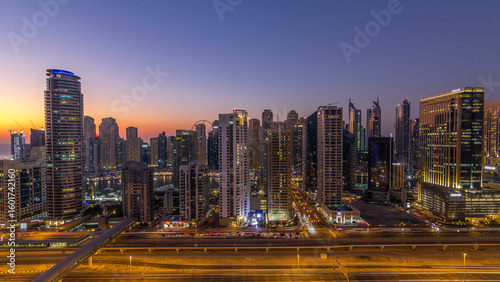 Photography Dubai marina with traffic on sheikh zayed road panorama day to night timelapse lights turn on