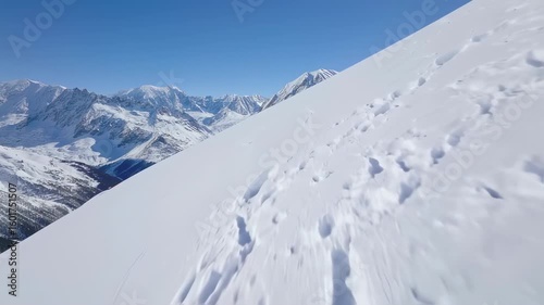 Snow-covered mountain slope with footprints