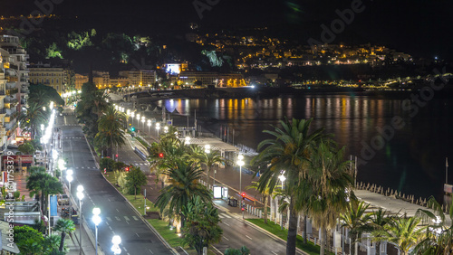 Fototapeta Naklejka Na Ścianę i Meble -  Night aerial panorama of Nice timelapse, France. Lighted Old Town little streets and waterfront