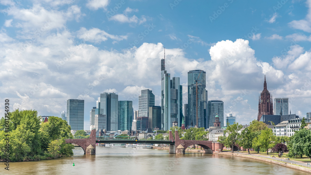 Obraz premium Hyperlapse of Frankfurt's skyscrapers skyline with the bell tower overlooking Alte Brucke. Frankfurt, Germany
