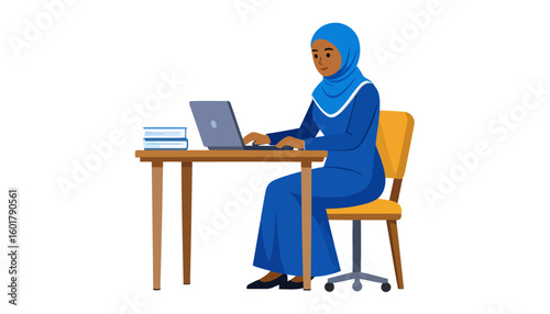 Smiling Muslim woman in a blue hijab and abaya working on a laptop computer at a wooden desk.