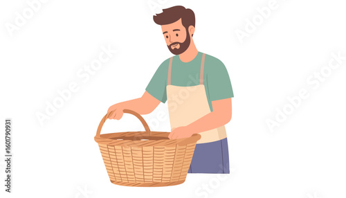 Friendly bearded man in a green shirt and apron holding a large empty wicker basket.