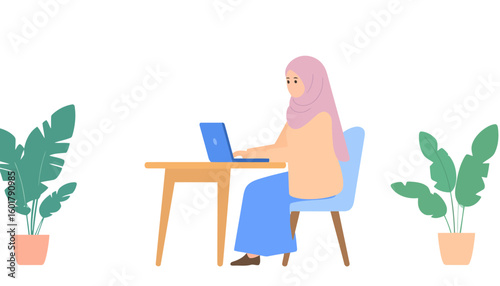 Muslim woman in a pink hijab and modest attire working on a laptop at her desk.