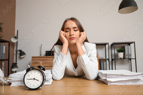 Tired businesswoman with al...