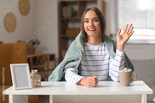 Young woman video chatting ...
