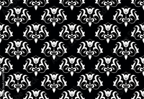 Wallpaper in the style of Baroque. White and black floral ornament. Seamless vector background. Graphic pattern for fabric, wallpaper, packaging. Ornate Damask flower illustration.
