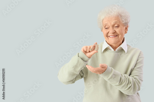 Senior woman with hearing a...