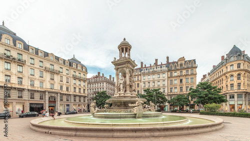 Fototapeta Naklejka Na Ścianę i Meble -  Hyperlapse of Place des Jacobins in Lyon, France, featuring the ornate Fontaine des Jacobins surrounded by historic buildings.