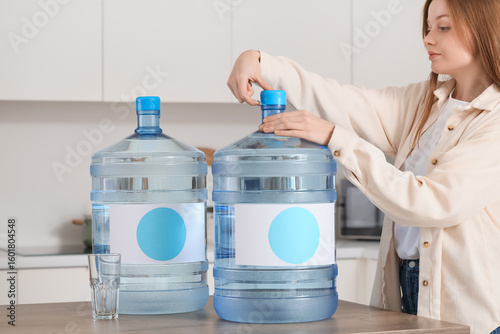 Young woman opening bottle ...