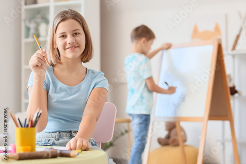 Teenage girl with pencil si...