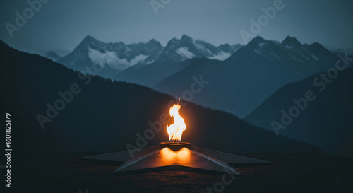  Striking Eternal Flame Monument Against a Dramatic Mountainous Backdrop at Twilight