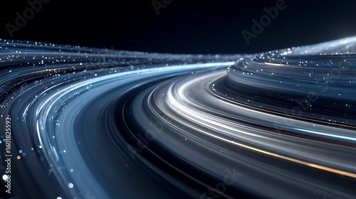 Streaks of light illuminate a winding road at night creating a sense of speed