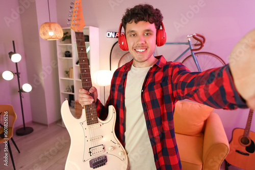 Male blogger with guitar re...