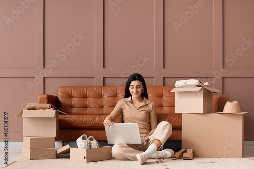 Young woman with laptop and...