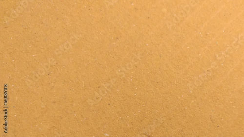Background of brown kraft paper or cardboard texture. Abstract pattern of beige rough carton, old paper sheet, parchment.