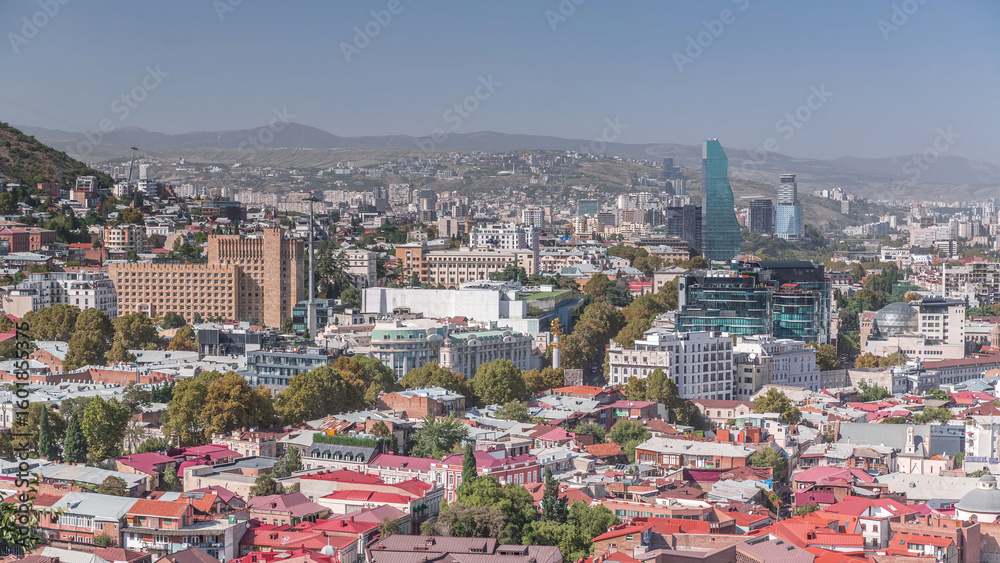 Fototapeta premium Cityscape panorama with glass tower of hotel in Tbilisi aerial timelapse, skyscrapers of Georgia