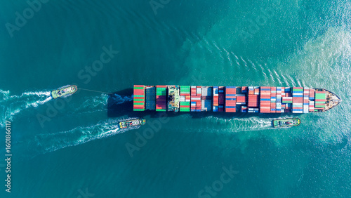 Aerial of cargo ship carrying container for export cargo from cargo yard port to other ocean concept smart freight shipping ship top view © Yellow Boat