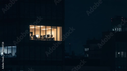 Office workspace illuminated at night with computers