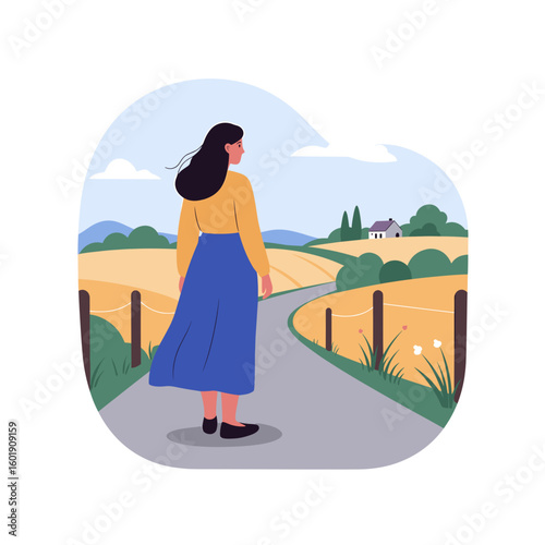 Young woman standing on country road looking at fields and hills  