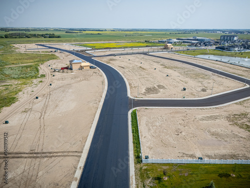 Road is shown in the distance with a few buildings in the background