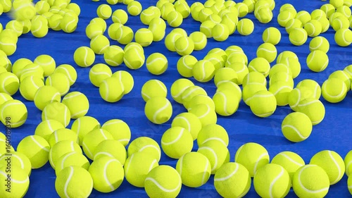 Random tennis balls shooting into an array of balls on a blue concrete surface