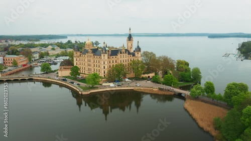 Panoramic view of Schwerin Castle in Germany, showcasing its grand towers, lakeside setting, and beautiful landscaped grounds. Ideal for tourism and architecture footage.