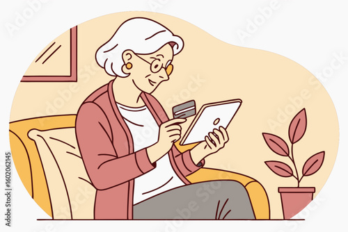 Elderly woman with glasses using a tablet and credit card while sitting on a couch at home