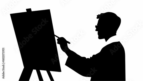 Silhouette of an artist painting on a canvas with an easel in a studio with a brush in his hand