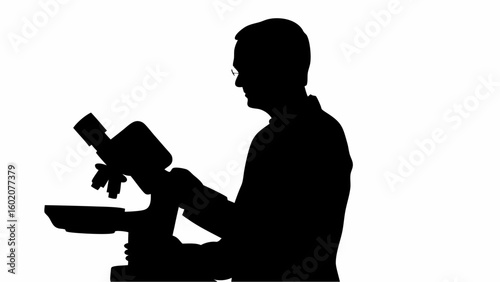 Silhouette of a scientist in lab coat using a microscope for research and analysis in a laboratory setting