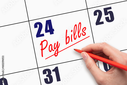 24th day of the month.  Hand writing Pay bills reminder and drawing a line on calendar with red pen on white background. Concept of financial planning reminder.  Planning and scheduling