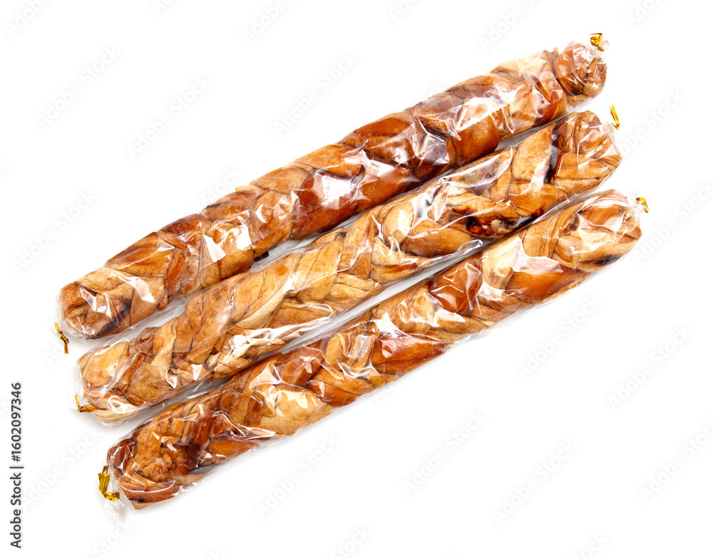 Three pieces of food are wrapped in plastic and placed on a white background