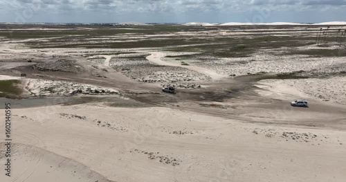 Wallpaper Mural Wide angle aerial view of a car driving through sandy surface of Jericoacoara in Brazil. Torontodigital.ca