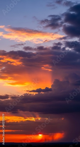 Dramatic sky with vibrant sunset colors and dark clouds creating a beautiful panorama view