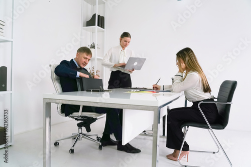 Team meeting in a modern office space discussing project strategies and deadlines