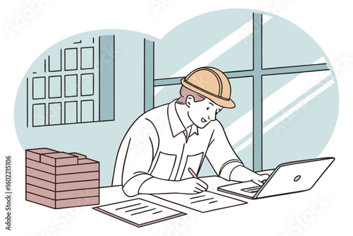 Construction worker reviewing project plans at a desk with computer and documents during work hours in a commercial office environment