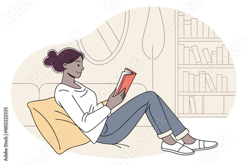 Relaxing at home with a book in a cozy living room setting featuring a comfortable sofa and a bookshelf in the background