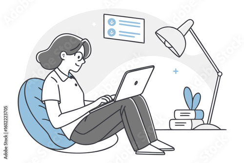 Person working on a laptop while seated comfortably in a bean bag in a cozy indoor workspace during the day