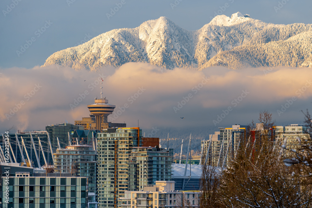 Fototapeta premium Snowcapped City in a lifting Fogbank