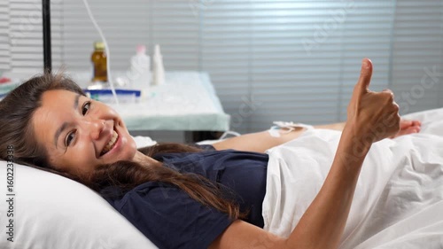 Happy Patient Gives Thumbs Up in Hospital Bed
