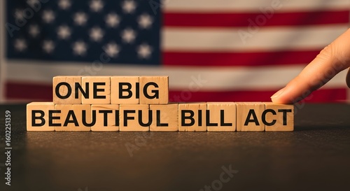 Wooden blocks spell out one big beautiful bill act with american flag background