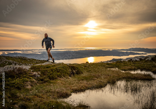 Man running in the Norwegian mountains of Bergen. 