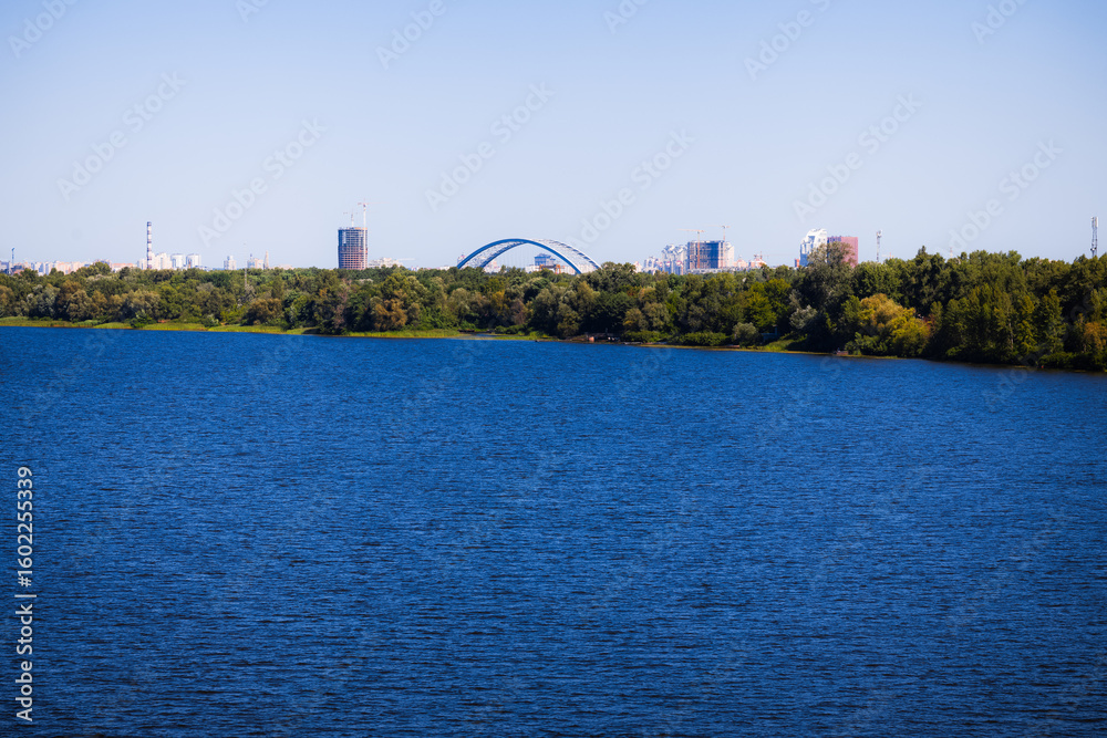 Fototapeta premium city nature waterfront district river panorama outskirts landscape with park and buildings background