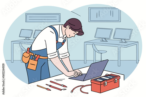 Technician working on a laptop at a tech repair shop during the day