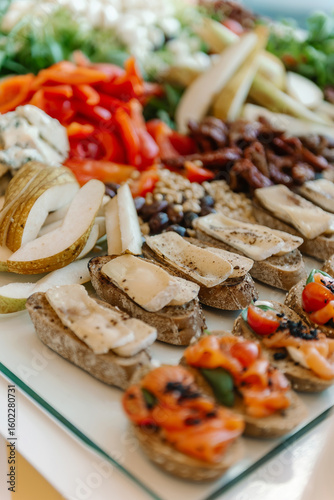 Beautifully served table with bruschetta, meat products and vegetables close-up