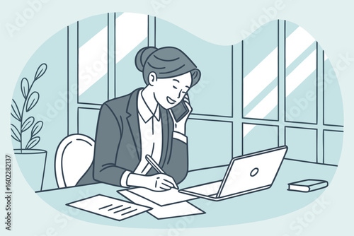 Businesswoman discussing plans on phone while taking notes and using laptop in bright office space with large windows and plant